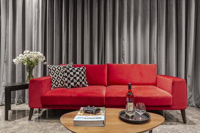 The stunning red sofa is the perfect fit for a contemporary apartment